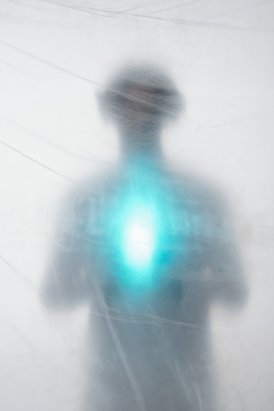 A Blurry Image of a Man Holding a Source of Light