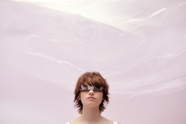 Close Up of a Futuristic Woman on a Light-Pink Background