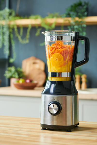 There Are Oranges and Carrots in a Blender to Make a Smoothie