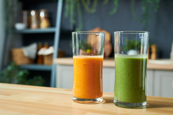 Orange and Green Smoothies in Glasses