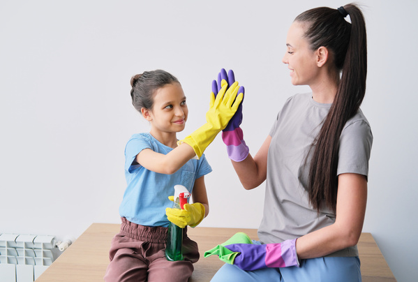 A Girl with Detergent Gives a High Five to Mother