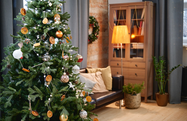 Christmas interior of a cozy room with a Christmas tree decorated with baubleoons and garlands a wreath and a floor lamp