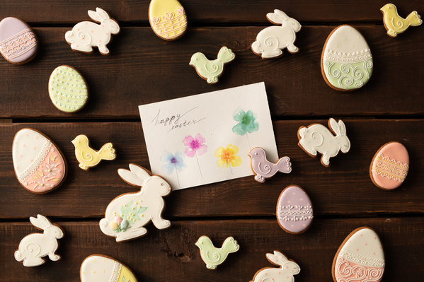 Easter greeting postcard with glazed treats in a themed design on a dark wood table