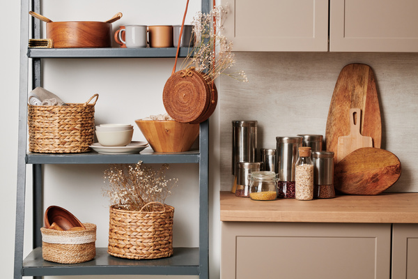 A kitchen shelf with kitchen eco friendly accessories and a beige set with a cutting board and cereals in glass and metal containers