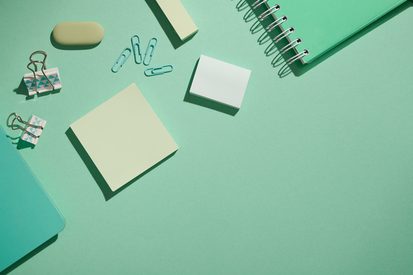 Top view of a kit of turquoise stationery items arranged on a matte surface