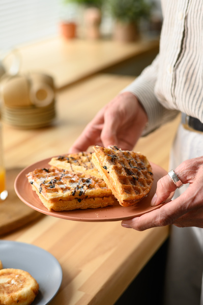 A Woman Holding a Plate of Viennese Waffles