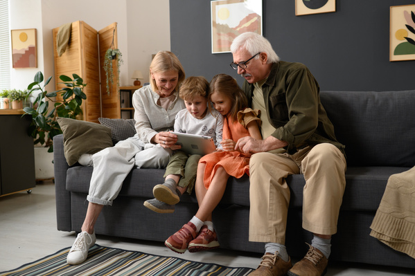 Senior Couple and Their Grandchildren Using a Tablet
