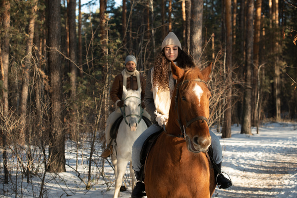 A Woman and Her Boyfriend Riding Horses in the Forest