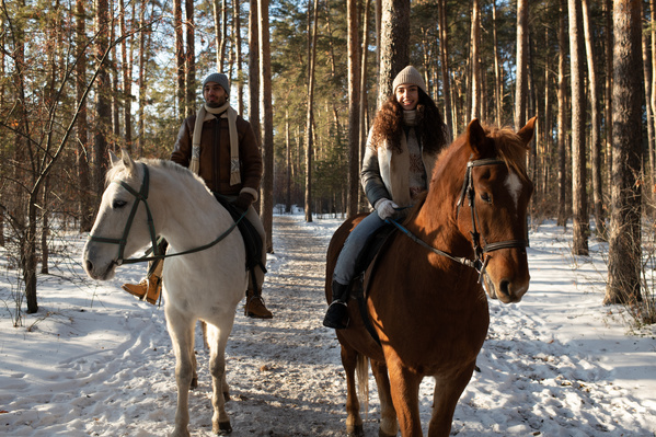 A Loving Couple Riding Horses in the Forest