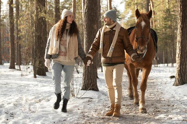 A Couple Walking with a Horse in the Forest
