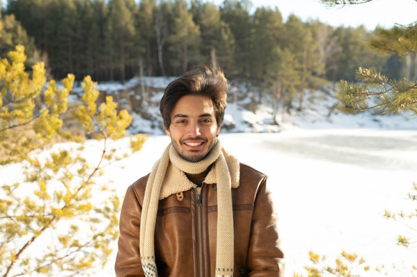 A Smiling Man in the Winter Forest