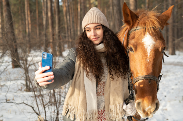 A Woman Taking a Selfie with a Horse