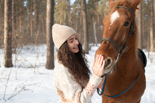 A Woman Stroking a Horse in the Forest
