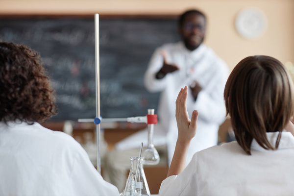 A Group of People in White Lab Coats in a Classroom Setting