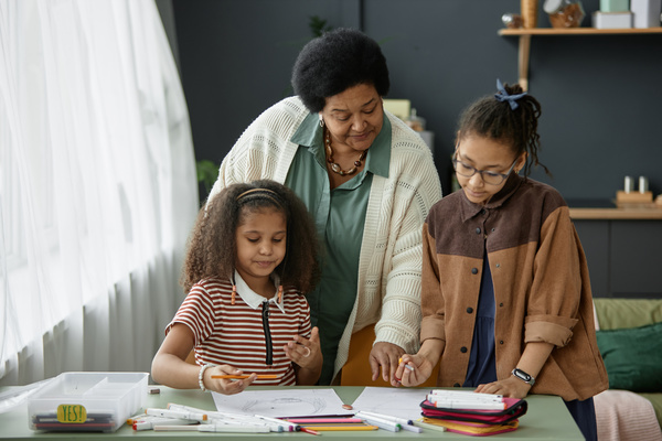 An African American Woman Helping Two Young Girls with Homework